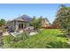 Expansive backyard featuring a well-maintained lawn, a patio with furniture, and a full yard fence at 5328 Potentilla St, Brighton, CO 80601