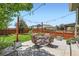 Outdoor patio featuring string lights, a dining table with chairs, and a landscaped yard at 5328 Potentilla St, Brighton, CO 80601