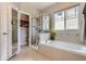 Bright bathroom with a shower, bathtub, and natural light from a window at 5328 Potentilla St, Brighton, CO 80601