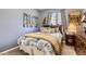Well-lit bedroom with a comfortable bed, unique artwork, and a large window at 5328 Potentilla St, Brighton, CO 80601