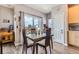Dining area with a view of the outdoor space with table for four and hardwood floor at 5328 Potentilla St, Brighton, CO 80601