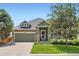 Charming home featuring a stone-accented facade, lush lawn, and well-manicured landscaping at 5328 Potentilla St, Brighton, CO 80601