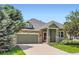 Charming home showcasing a stone facade, inviting front porch, and a well-manicured lawn at 5328 Potentilla St, Brighton, CO 80601