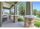 Covered front porch with stone pillars and a view of the street at 5328 Potentilla St, Brighton, CO 80601