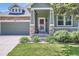 Inviting front porch of home featuring stone pillars and a well-maintained lawn at 5328 Potentilla St, Brighton, CO 80601