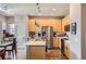Well-lit kitchen featuring stainless steel appliances and a modern island with sink at 5328 Potentilla St, Brighton, CO 80601