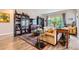 Bright living room featuring built-in bookcases, a large window, and comfortable seating area at 5328 Potentilla St, Brighton, CO 80601