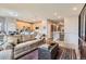 Open concept living room with a modern kitchen and staircase access to the second floor at 5328 Potentilla St, Brighton, CO 80601