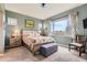Bright main bedroom with a ceiling fan, a large window, and ample natural light at 5328 Potentilla St, Brighton, CO 80601