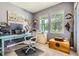 Well-appointed home office with a large desk, ergonomic chair, and natural light at 5328 Potentilla St, Brighton, CO 80601