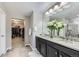 Bright bathroom featuring a double vanity with granite countertop and a walk-in closet at 12631 Glencoe St, Thornton, CO 80241