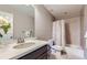 Well-lit bathroom featuring a vanity sink, framed mirror, and a shower-tub combination at 12631 Glencoe St, Thornton, CO 80241