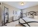 Charming bedroom with a wrought iron bed frame, neutral walls, and a full-length mirror at 12631 Glencoe St, Thornton, CO 80241