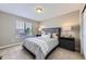 Cozy bedroom with a large window providing natural light, neutral walls and carpet at 12631 Glencoe St, Thornton, CO 80241
