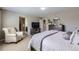 Tranquil bedroom with a cozy chair and a large window providing natural light at 12631 Glencoe St, Thornton, CO 80241