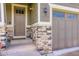 Inviting entryway with a solid front door, stone accents, and coach lights illuminating the facade at 12631 Glencoe St, Thornton, CO 80241