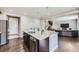 Beautiful kitchen island with stone countertops and stainless steel appliances at 12631 Glencoe St, Thornton, CO 80241