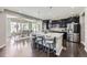 Spacious kitchen features a large island and dark cabinetry with stainless steel appliances at 12631 Glencoe St, Thornton, CO 80241