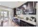 This kitchen has granite countertops, dark cabinets, and stainless steel appliances at 12631 Glencoe St, Thornton, CO 80241