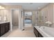 Open ensuite bathroom area showcasing the soaking tub and walk-in shower at 4545 S Monaco St # 328, Denver, CO 80237