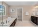 Luxurious bathroom with a soaking tub and a view into the walk-in closet at 4545 S Monaco St # 328, Denver, CO 80237