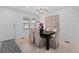 Bright dining room featuring a modern chandelier and an elegant, painted white brick accent wall at 4545 S Monaco St # 328, Denver, CO 80237