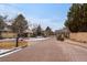 Gated community entrance with brick-paved road, landscaped grounds and well-maintained surroundings at 4545 S Monaco St # 328, Denver, CO 80237