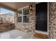 Charming front porch showcasing a brick facade, large window, and a welcoming welcome mat at 4545 S Monaco St # 328, Denver, CO 80237