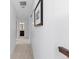 Hallway with carpet, white walls, picture, and dark wood trim at 4545 S Monaco St # 328, Denver, CO 80237