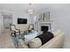 Bright living room with a white brick fireplace, patterned rug, and ample natural light at 4545 S Monaco St # 328, Denver, CO 80237