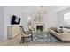 Bright living room featuring fireplace, large TV, modern furniture, and a decorative black-and-white rug at 4545 S Monaco St # 328, Denver, CO 80237