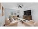 Bright living room with white brick wall, plush seating, ceiling fan, and marble-topped coffee table at 4545 S Monaco St # 328, Denver, CO 80237