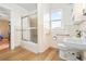 This bathroom features a tub/shower combo with a sliding door and white fixtures at 276 N 5Th Ave, Brighton, CO 80601
