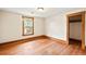 An empty bedroom with hardwood floors, natural wood trim, and bright natural light at 276 N 5Th Ave, Brighton, CO 80601