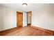 An empty bedroom with hardwood floors, natural wood trim, and bright natural light at 276 N 5Th Ave, Brighton, CO 80601