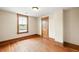 An empty bedroom with hardwood floors, natural wood trim, and bright natural light at 276 N 5Th Ave, Brighton, CO 80601