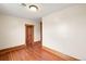 This bedroom has wood floors, a door, and neutral-colored walls that are move-in ready at 276 N 5Th Ave, Brighton, CO 80601