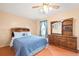 Comfortable bedroom with ceiling fan and a classic wood dresser with large mirror at 276 N 5Th Ave, Brighton, CO 80601