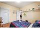 A cozy bedroom with hardwood floors and decorative shelves and bright natural light at 276 N 5Th Ave, Brighton, CO 80601