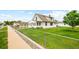 Charming two-story home with a well-maintained lawn and chain-link fence at 276 N 5Th Ave, Brighton, CO 80601