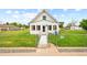 Inviting home exterior featuring a well-manicured front lawn and a charming white picket fence at 276 N 5Th Ave, Brighton, CO 80601