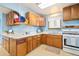Cozy kitchen features vintage cabinetry, ample counter space, and window views of the backyard at 276 N 5Th Ave, Brighton, CO 80601