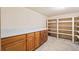 This walk-in pantry features wooden cabinets and shelves, perfect for storing food at 276 N 5Th Ave, Brighton, CO 80601