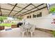 This covered patio features a dining table, outdoor seating, and a tranquil backyard at 276 N 5Th Ave, Brighton, CO 80601