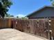 View of a weathered backyard wood fence with a concrete patio at 12252 Elmendorf Pl, Denver, CO 80239