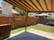 View of the backyard featuring a partially covered patio and horizontal wood fence at 12252 Elmendorf Pl, Denver, CO 80239
