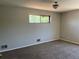 Bedroom featuring neutral carpet and paint and a centered window for natural light at 12252 Elmendorf Pl, Denver, CO 80239