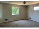 Bedroom featuring neutral carpet and paint with ample natural light from two windows at 12252 Elmendorf Pl, Denver, CO 80239
