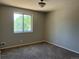 Bedroom featuring neutral carpet and paint and a large window for natural light at 12252 Elmendorf Pl, Denver, CO 80239