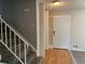 View of a home entryway with hardwood floors and a carpeted staircase at 12252 Elmendorf Pl, Denver, CO 80239